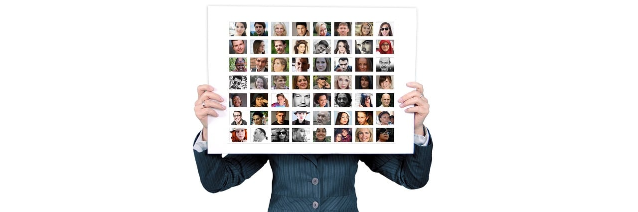 a man holding up a picture of a bunch of people, a photo, trending on pixabay, visual art, different women's faces, billboard image, face-on head shot, contact sheet