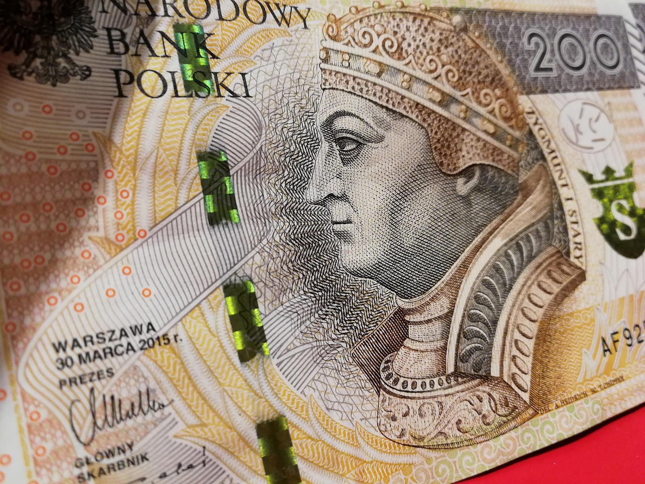 a close up of a bank note on a red surface, inspired by Károly Markó the Elder, holography, portrait of the holy father, in legnica!!!, green skin. intricate, jackstraws