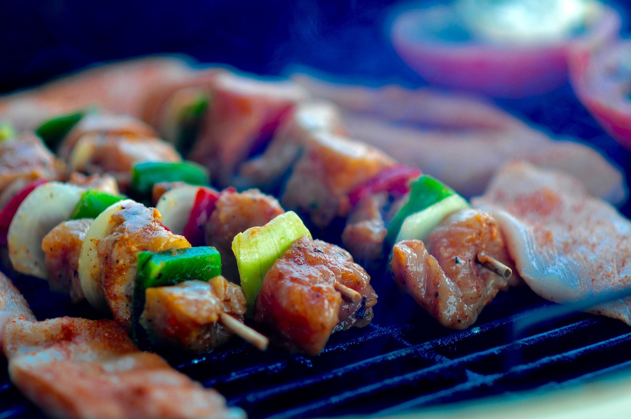 a close up of a grill with meat and vegetables on it, pexels, sloppy, food blog photo, chicken, hotdogs