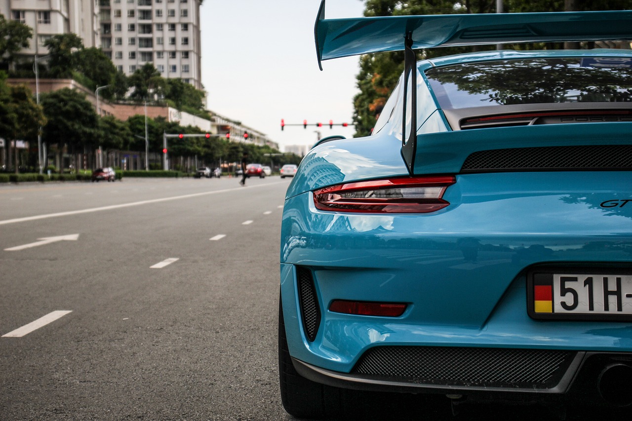 a blue sports car parked on the side of the road, by Etienne Delessert, pexels contest winner, photorealism, porsche rsr, close-up shot from behind, colored accurately, gtr xu1