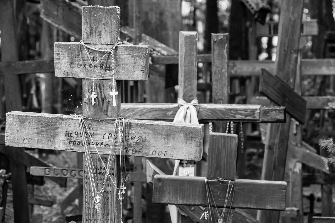 a black and white photo of a wooden cross, las pozas, neck chains, multiple, aleksander rostov