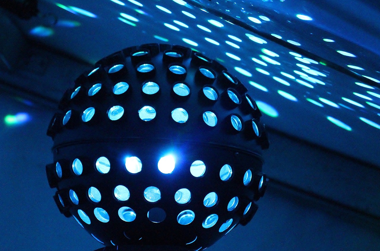 a close up of a disco ball with lights in the background, by Matt Stewart, glowing tiny blue lines, line dancing at a party, microphone silluette, dots abstract