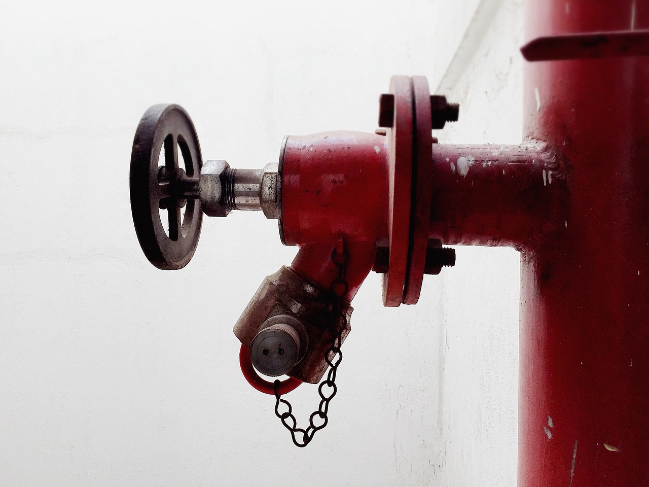 a red fire hydrant with a chain attached to it, a photo, by Bernardino Mei, bauhaus, mechanism, torch, closeup photo, very accurate photo