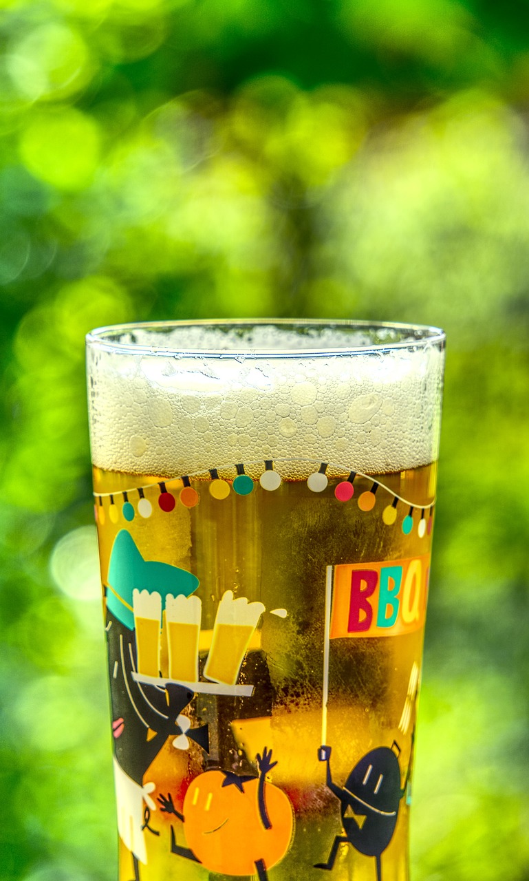 a glass of beer sitting on top of a table, a picture, shutterstock, hot summer day, bokeh details, hight decorated, garden behind the glasses