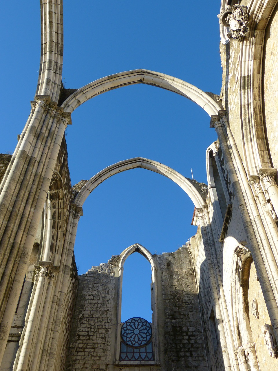 a view of the inside of a cathedral, a picture, pexels, romanesque, crumbling ancient skyscrapers, portugal, flying buttresses, straw