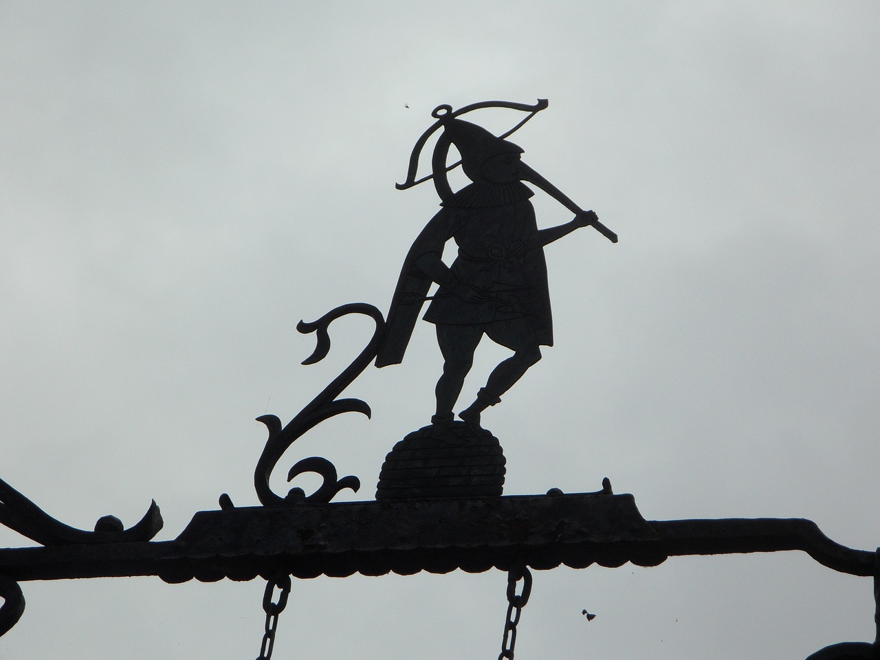 a clock mounted to the side of a building, a statue, inspired by Makuzu Kōzan, flickr, folk art, an umbrella top, single silhouette figure, wielding a decorated halberd, richard iv the roman king photo