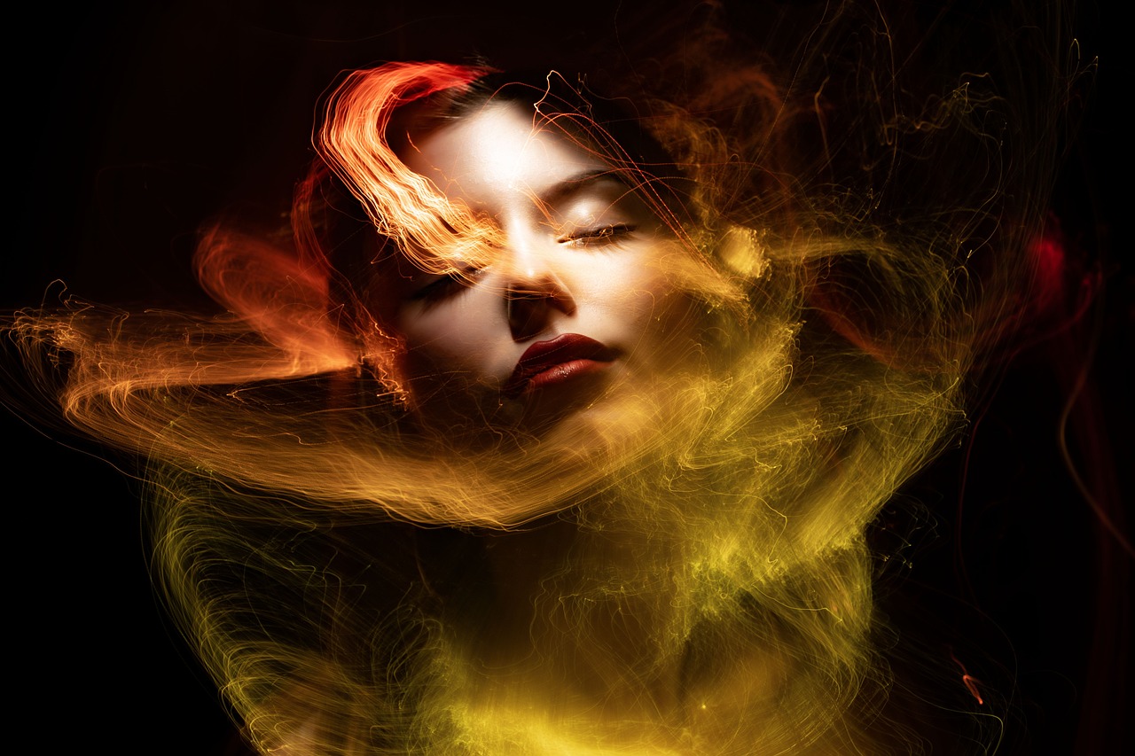a woman with her hair blowing in the wind, by Galen Dara, digital art, red and yellow light, lights and smoke, vertical portrait, yellow and red color scheme