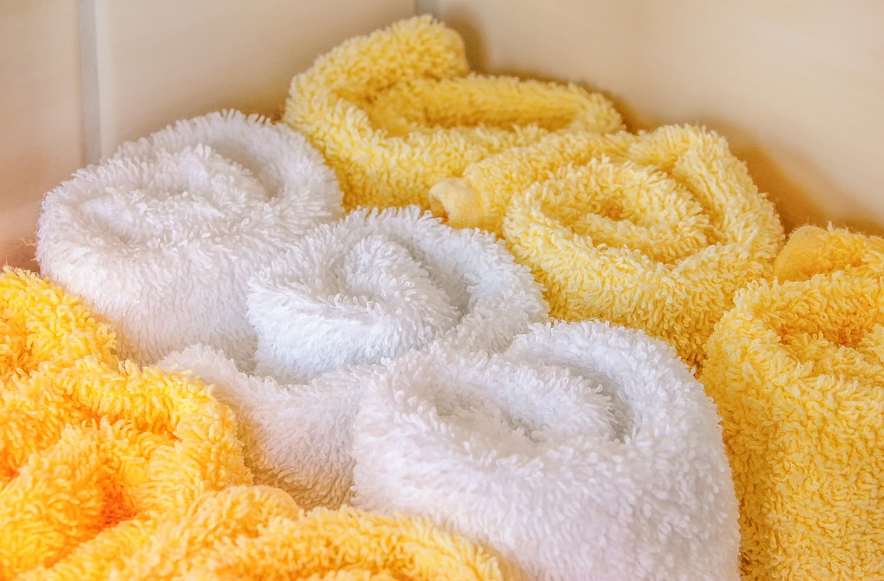 a box filled with yellow and white towels, inspired by Leo Leuppi, pexels, process art, white spiral horns, close up. macro. hyper realistic, hearts, bright towels