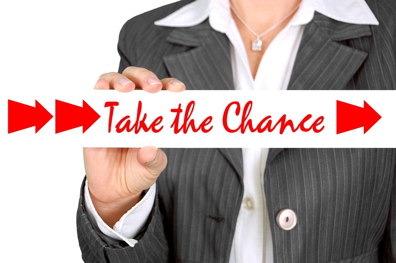 a woman in a business suit holding a sign that says take the chance, by Jeanna bauck, pixabay contest winner, 🕹️ 😎 🔫 🤖 🚬, an ultra realistic, hr, splash image