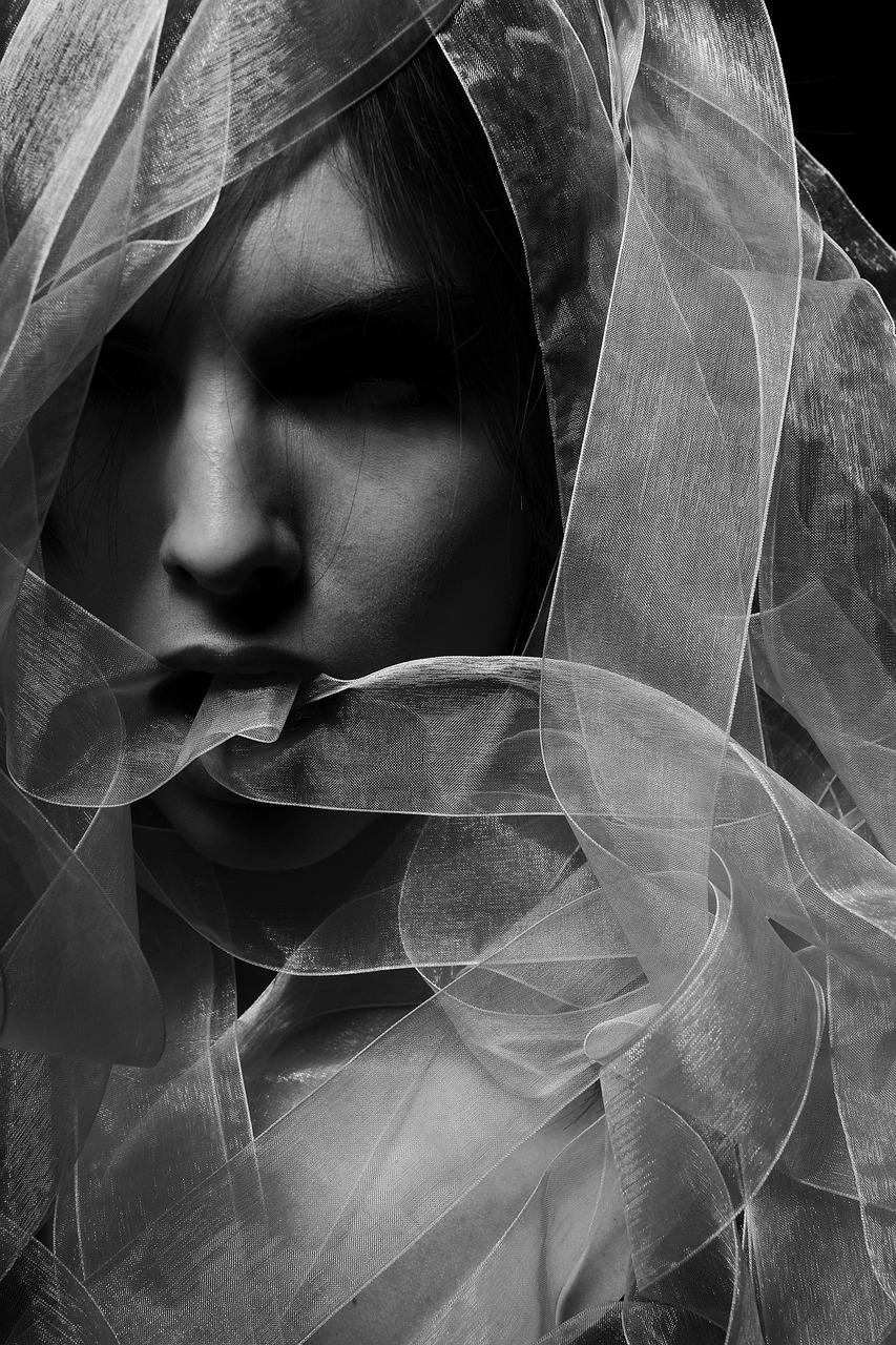 a black and white photo of a woman with a veil over her head, inspired by Katia Chausheva, art photography, made with zbrush, subject made of white mesh rope, in style of caravaggio, ray swanland