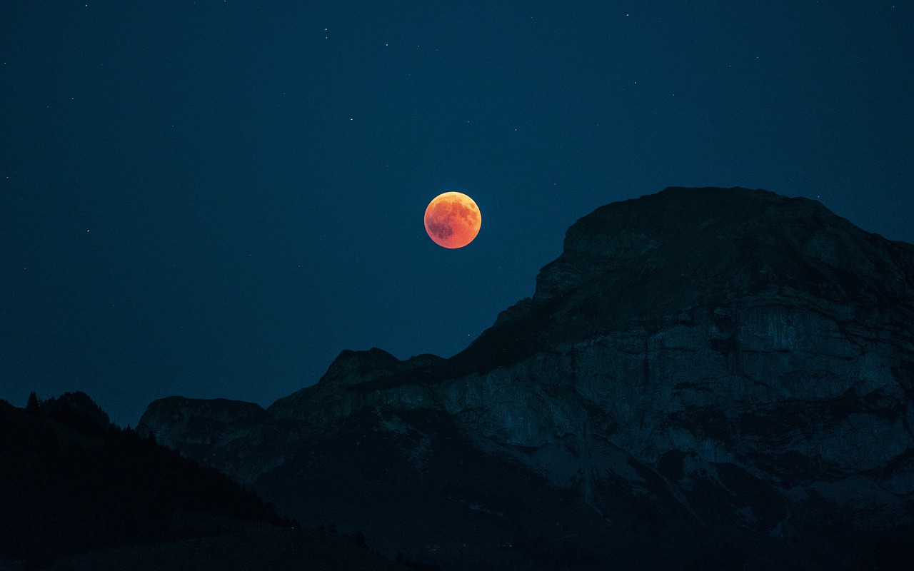 a full moon in the sky with a mountain in the background, by Raphaël Collin, unsplash contest winner, red lunar eclipse, stunning screensaver, ✨🕌🌙, light red and deep blue mood