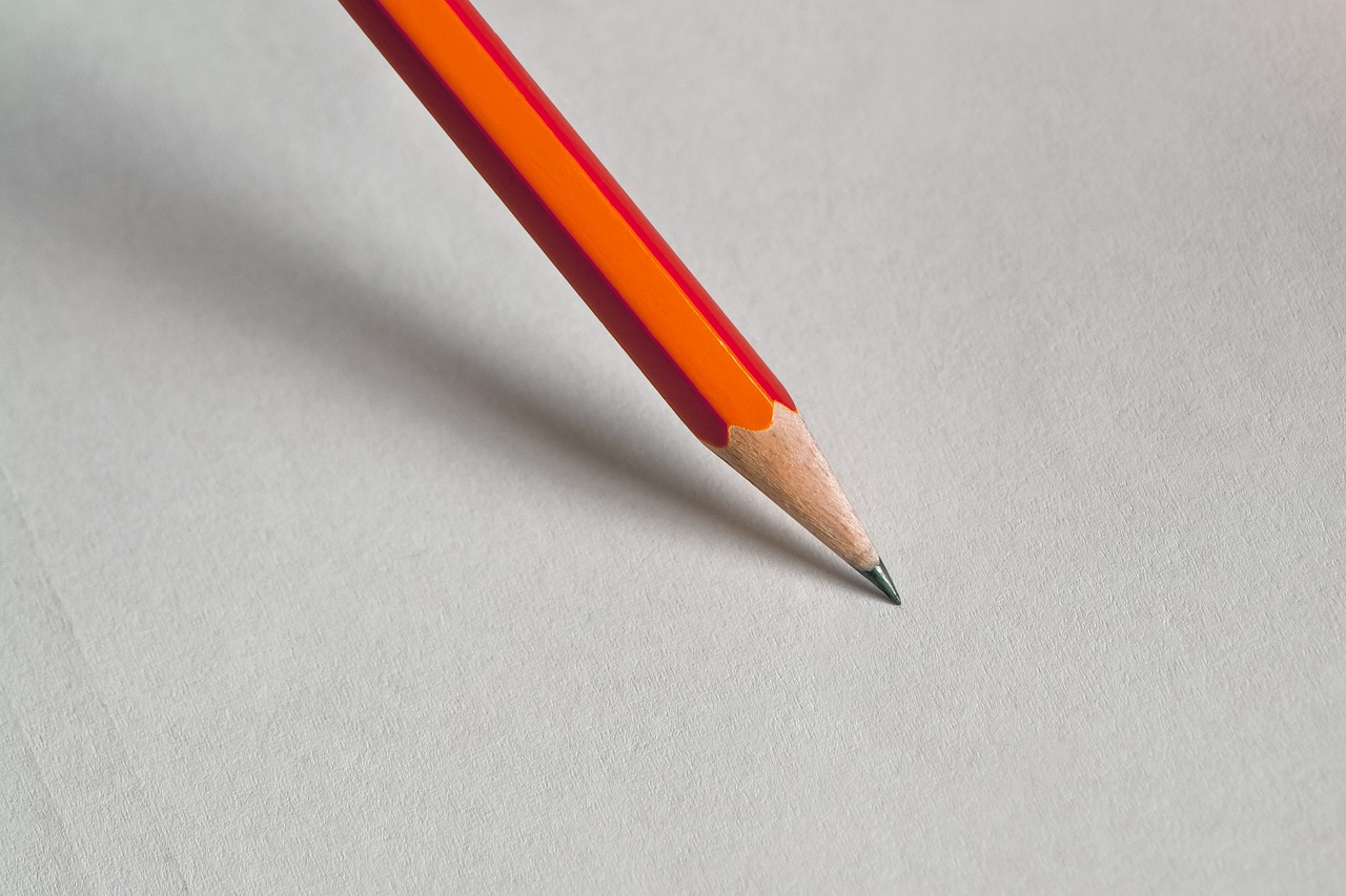 a red pencil sitting on top of a piece of paper, a macro photograph, by Jan Rustem, grey orange, close-up product photo, sharp focus illustration, highly detailed product photo