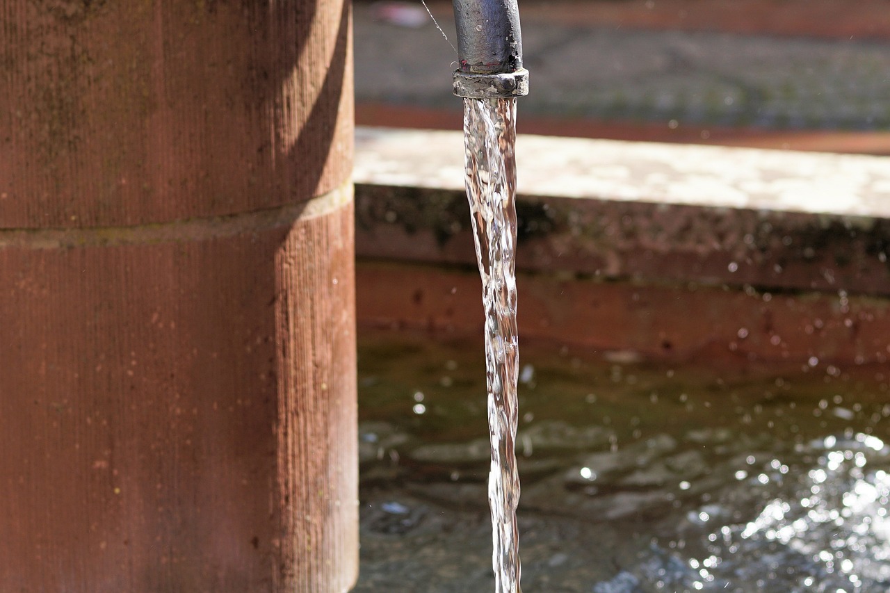 a close up of a faucet with water coming out of it, a picture, by Jan Tengnagel, shutterstock, sewer pipe entrance, in sunny weather, stock photo, hd footage