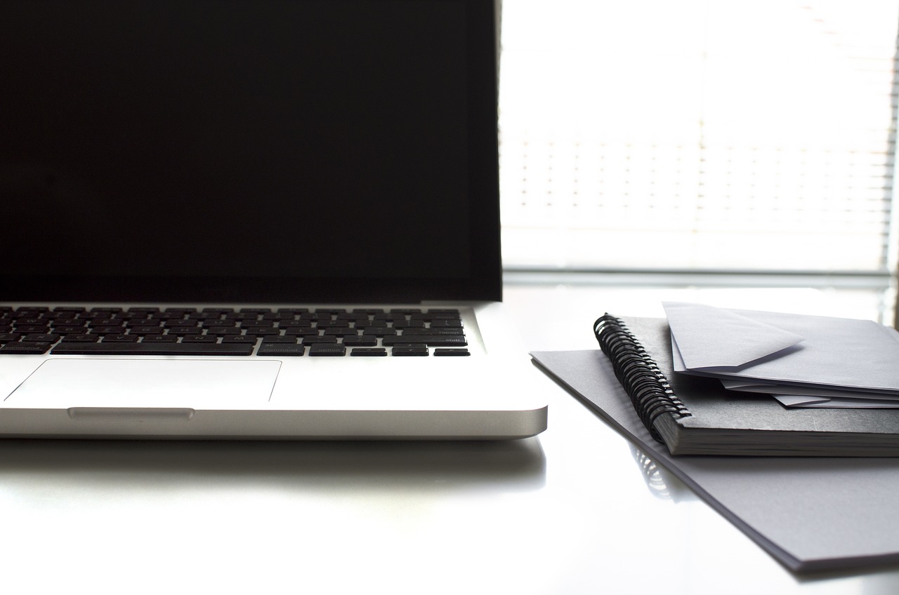 a laptop computer sitting on top of a white desk, by Robbie Trevino, close - up studio photo, documents, half body photo