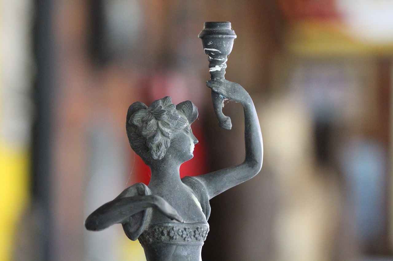 a statue of a woman holding a lit candle, a statue, flickr, folk art, twirling, overturned chalice, profile close-up view, dancing character