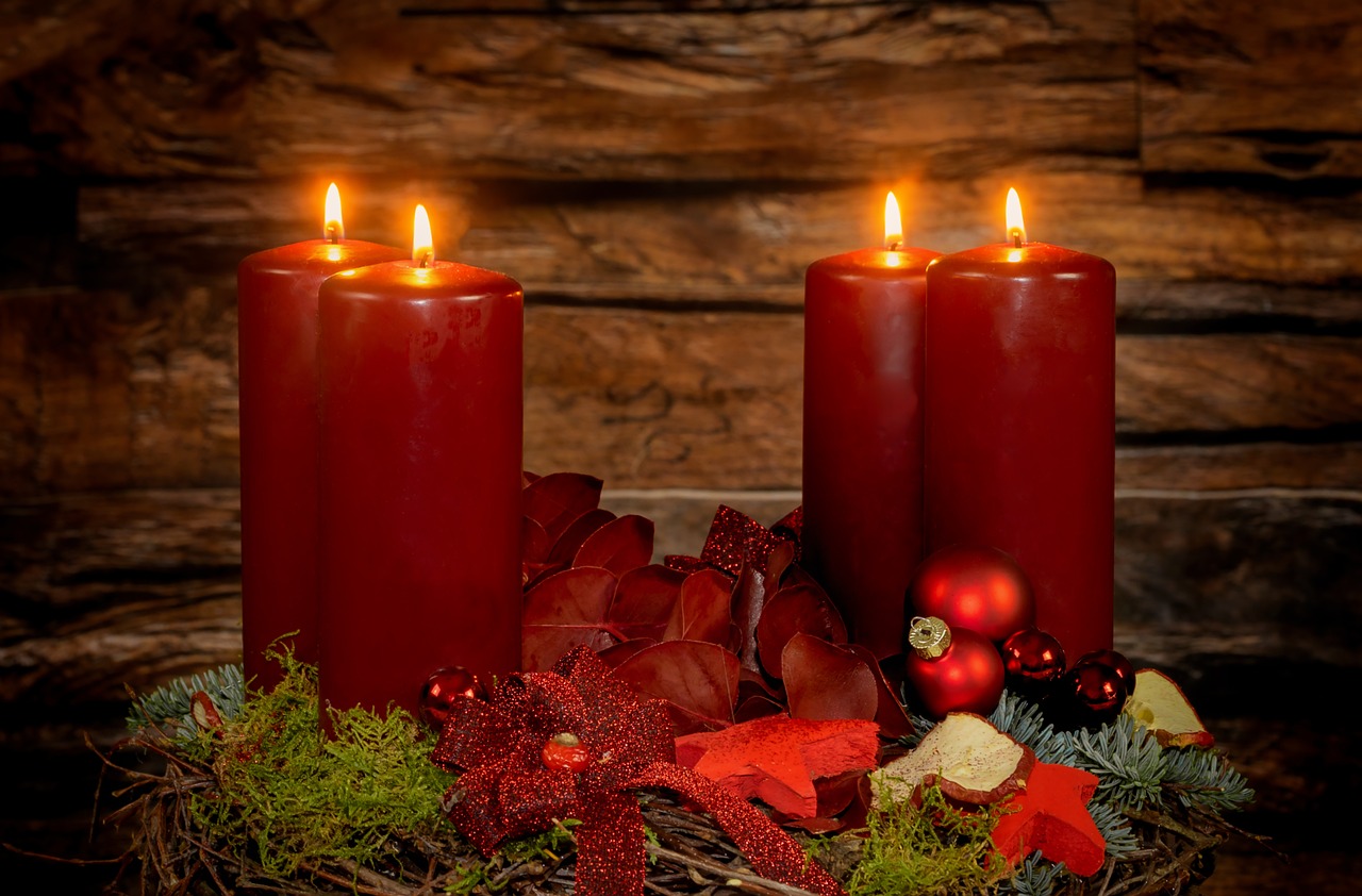 a couple of red candles sitting on top of a table, shutterstock, wooden, awesome greate composition, epiphany, red color scheme