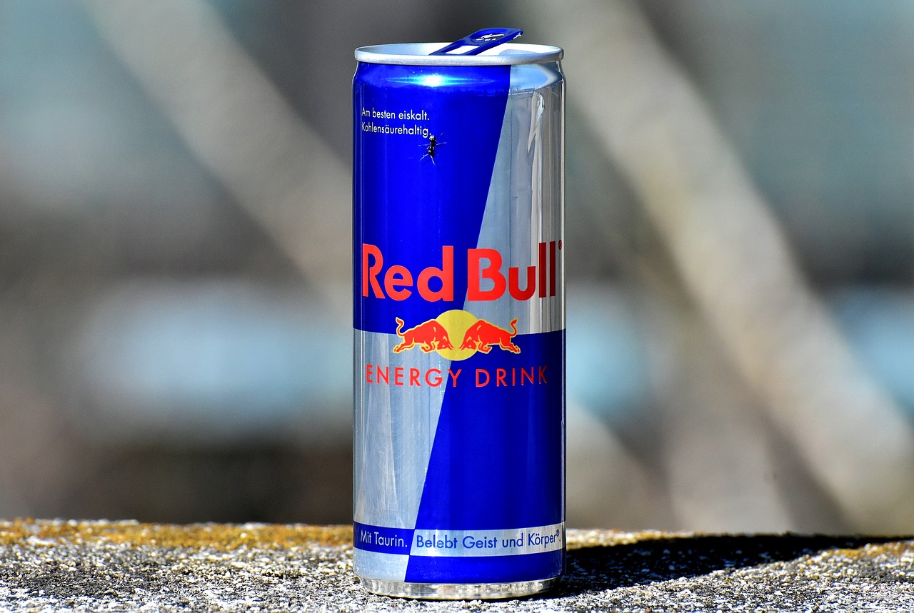 a can of red bull energy drink sitting on a ledge, by Paul Emmert, pexels, hurufiyya, very very realistic, that resembles a bull\'s, 🦩🪐🐞👩🏻🦳, stock photo