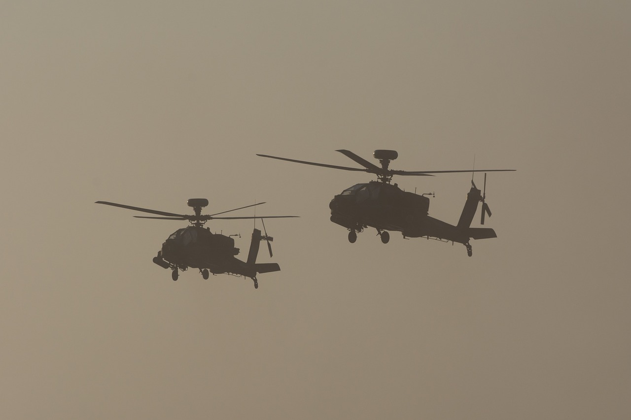 two military helicopters flying side by side in the sky, dau-al-set, in a sunset haze, 1/1250s at f/2.8, dubai, full image