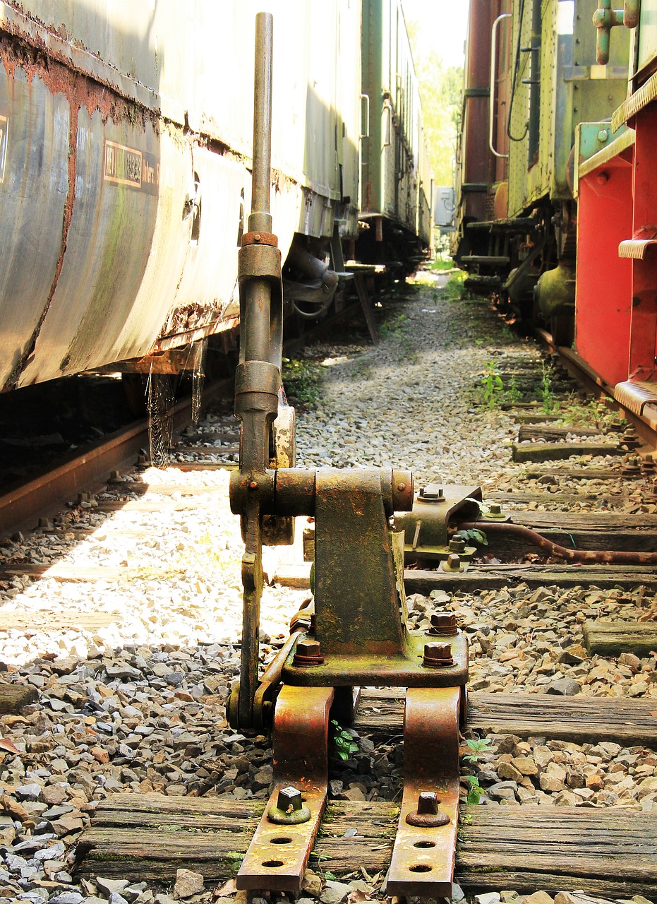 a close up of a train on a train track, by Douglas Shuler, flickr, junkyard, brass and steam technology, mechanical limbs, saws