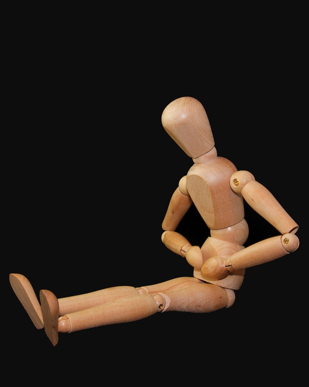 a wooden mannequin sitting on a black surface, figuration libre, fully posable, illustration!, toy photo, lying on back