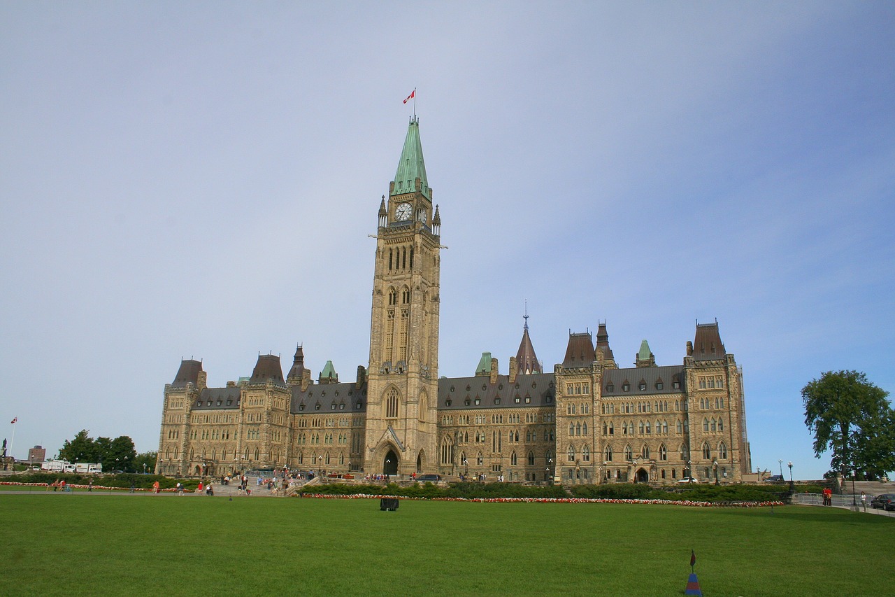 a large building with a clock tower on top of it, by Susan Heidi, flickr, hurufiyya, parliament, canada, grass, tall terrace