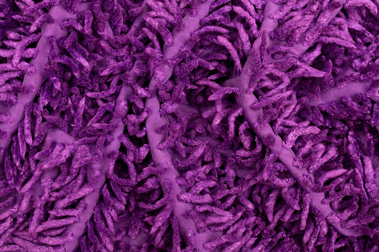 a pile of purple yarn sitting on top of a table, a microscopic photo, inspired by Benoit B. Mandelbrot, flickr, generative art, melting in coral pattern, 8 k hyper detailed image, full body close-up shot, cellular automata