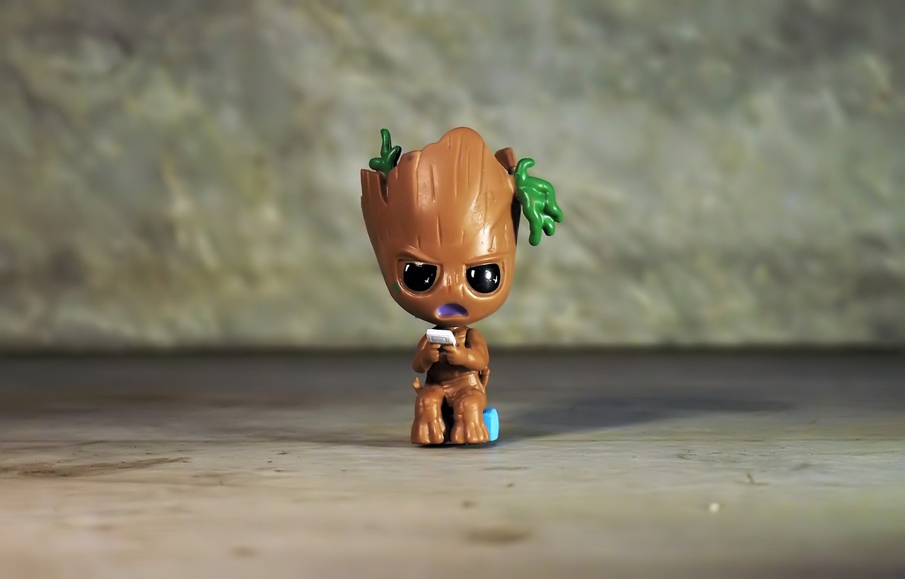 a close up of a small toy on a table, pexels, groot, she has olive brown skin, high quality fantasy stock photo, squatting