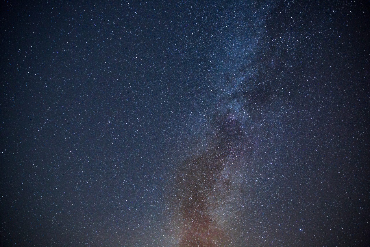 the milky shines brightly in the night sky, a portrait, minimalism, ultra wide shot, outworldly colours, 1128x191 resolution, low angle photo