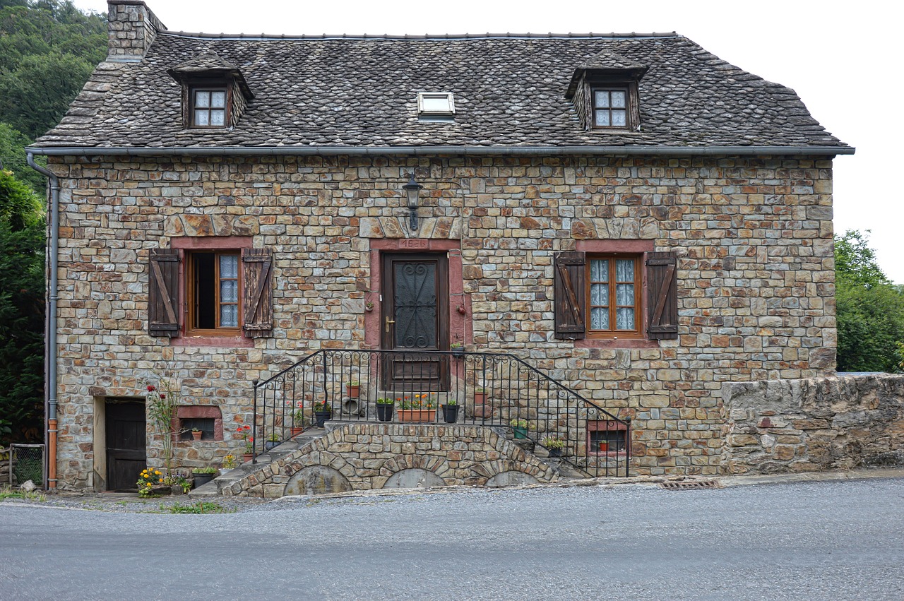 a stone house sitting on the side of a road, by Cedric Peyravernay, pixabay, renaissance, freddy mamani silvestre facade, studio la cachette, frontal view, rustic