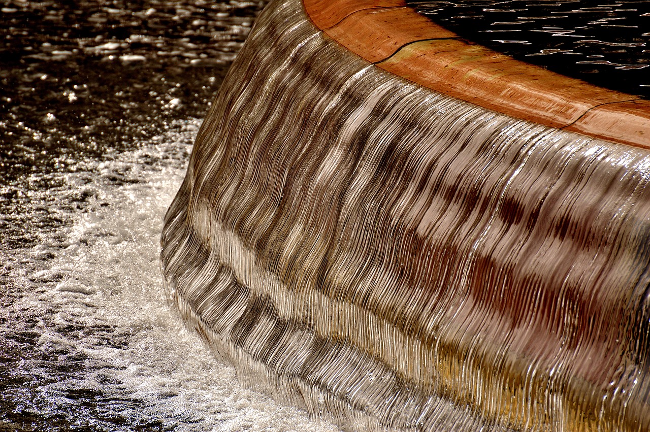 a close up of a fountain with water coming out of it, an abstract sculpture, flickr, striations, detailed wood, hdr detail, flowing fabric