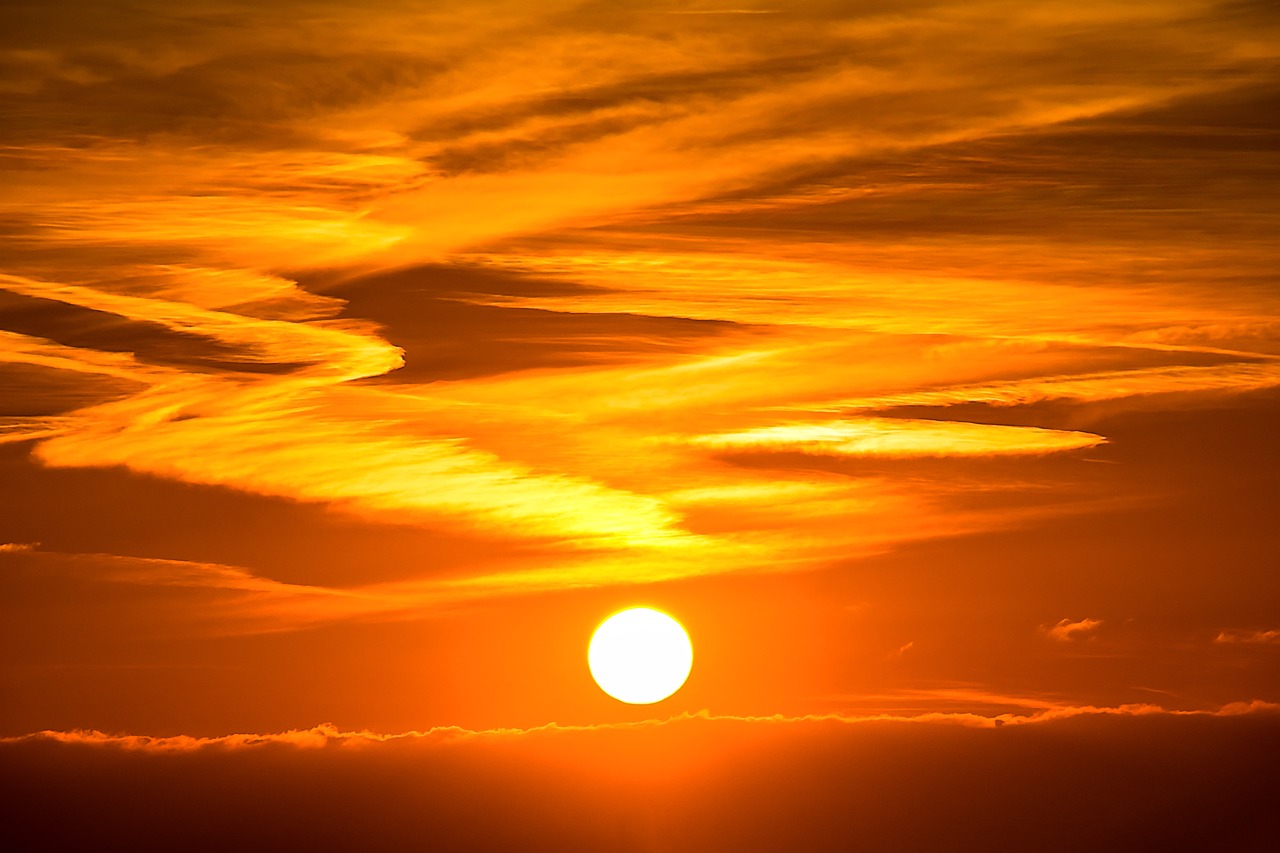 the sun is setting over a body of water, by Hans Schwarz, pexels, romanticism, digital yellow red sun, sunset in the clouds, break of dawn on venus, yellow orange