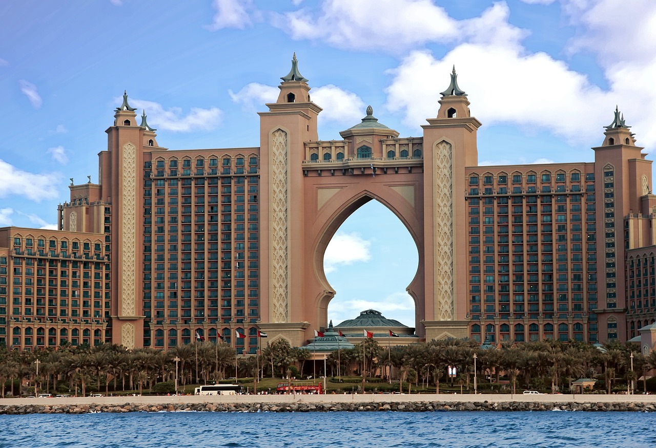 a large building in the middle of a body of water, renaissance, atlantis city, huge gate, high res photo, in a beachfront environment