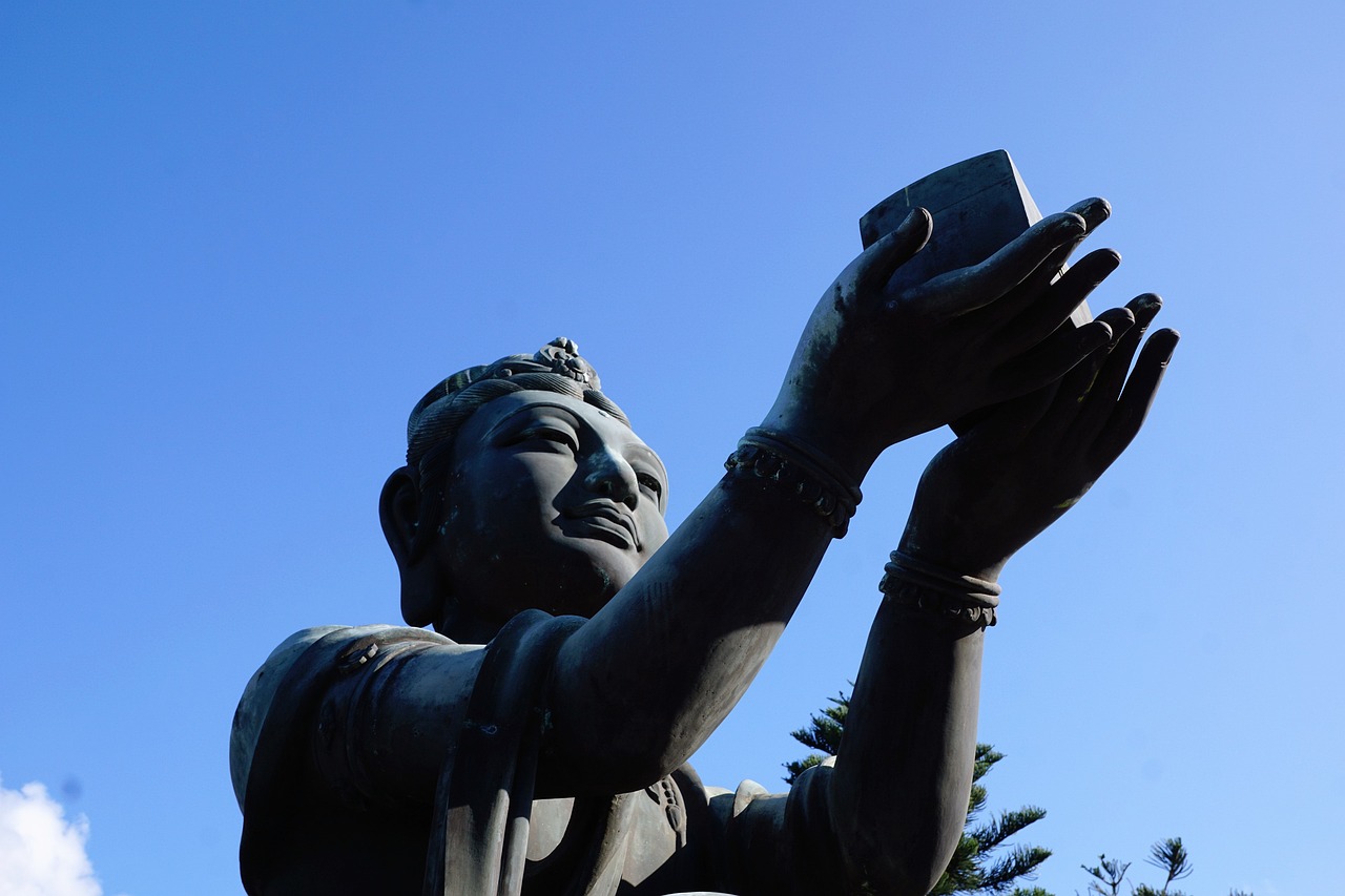 a statue of a person holding a cell phone, a statue, figuration libre, asia, selfie photo, low angle photo, the buddha