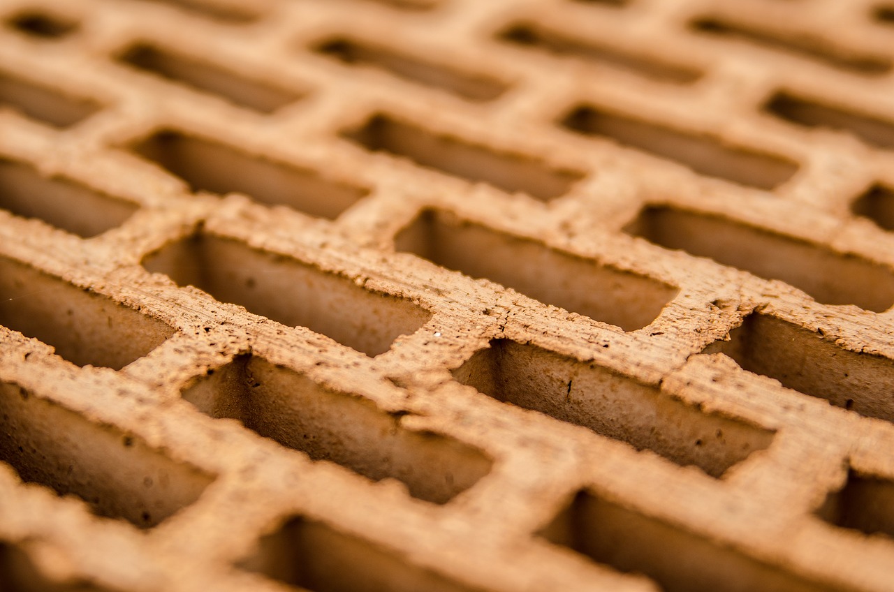 a close up of a brick wall with holes in it, a macro photograph, shallow dof, close-up product photo