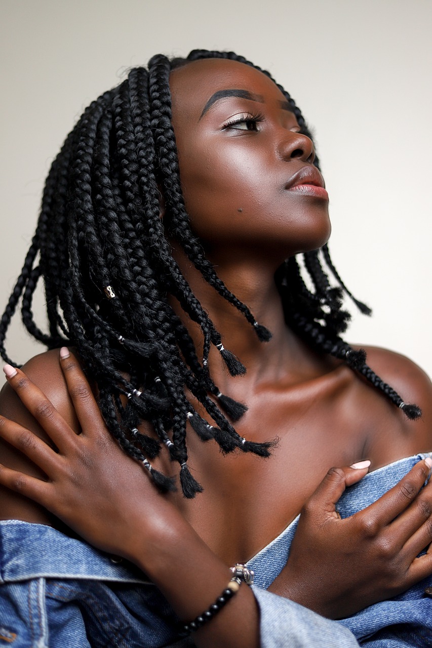 a close up of a person holding a cell phone, a black and white photo, inspired by Ras Akyem, hyperrealism, two long braids blue, model with attractive body, hair floating covering chest, 2 4 year old female model