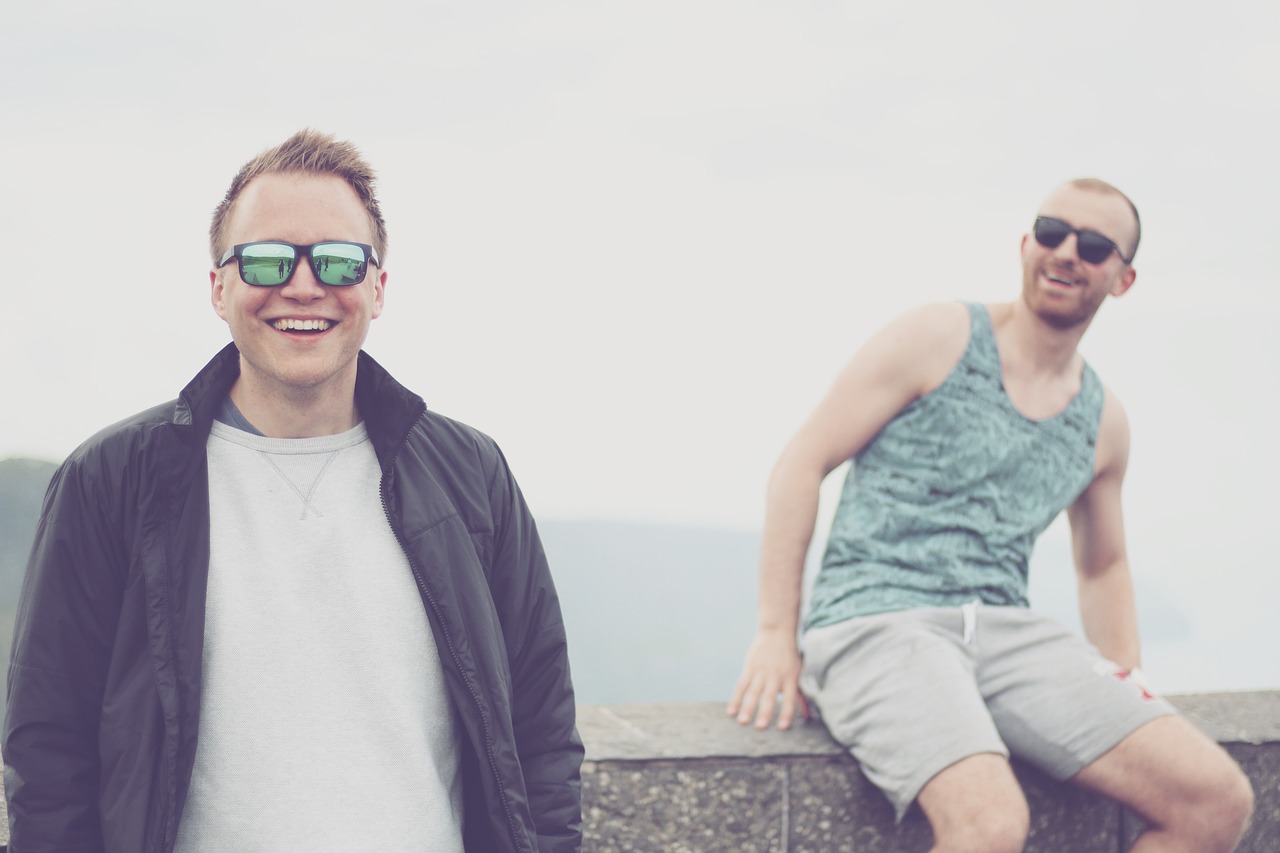 a couple of men standing next to each other, unsplash, happening, wearing shades, over a cliff, shaven, highkey