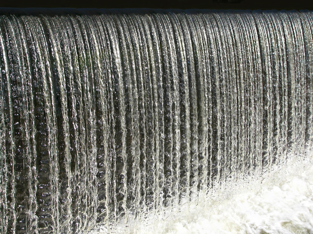 a man riding a surfboard on top of a waterfall, a picture, pixabay, hurufiyya, detail texture, irrigation, waterfall falling into a lake, (waterfall)