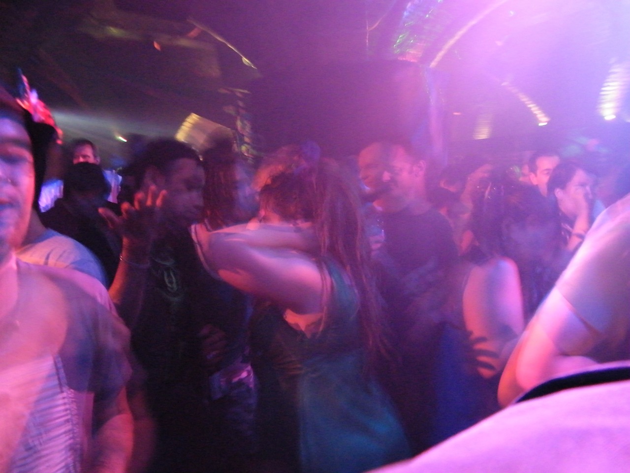 a group of people dancing at a party, a picture, psytrance, making out, haze over the shoulder shot, very poor quality of photography