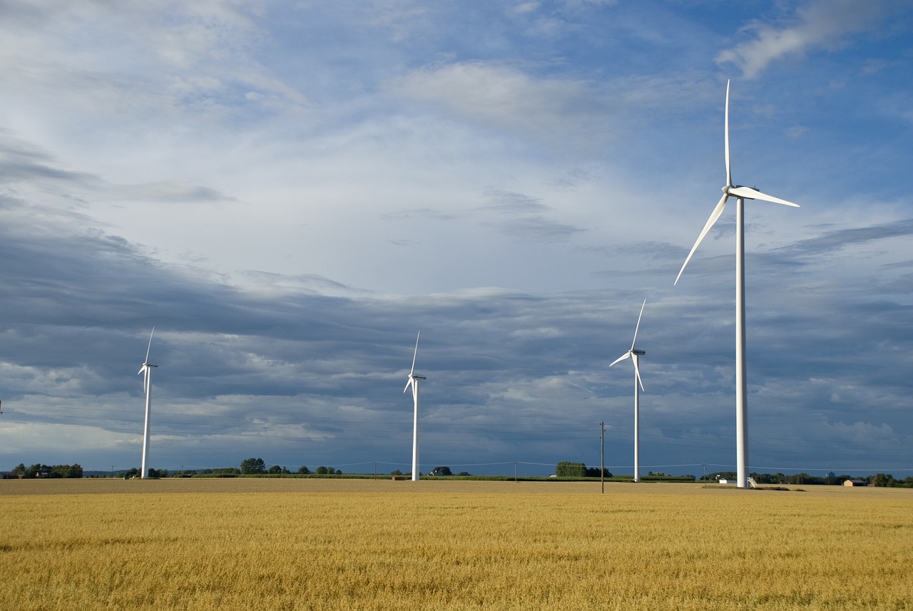 a group of wind turbines sitting on top of a dry grass field, a picture, shutterstock, figuration libre, wide view of a farm, iowa, usa-sep 20, sweden