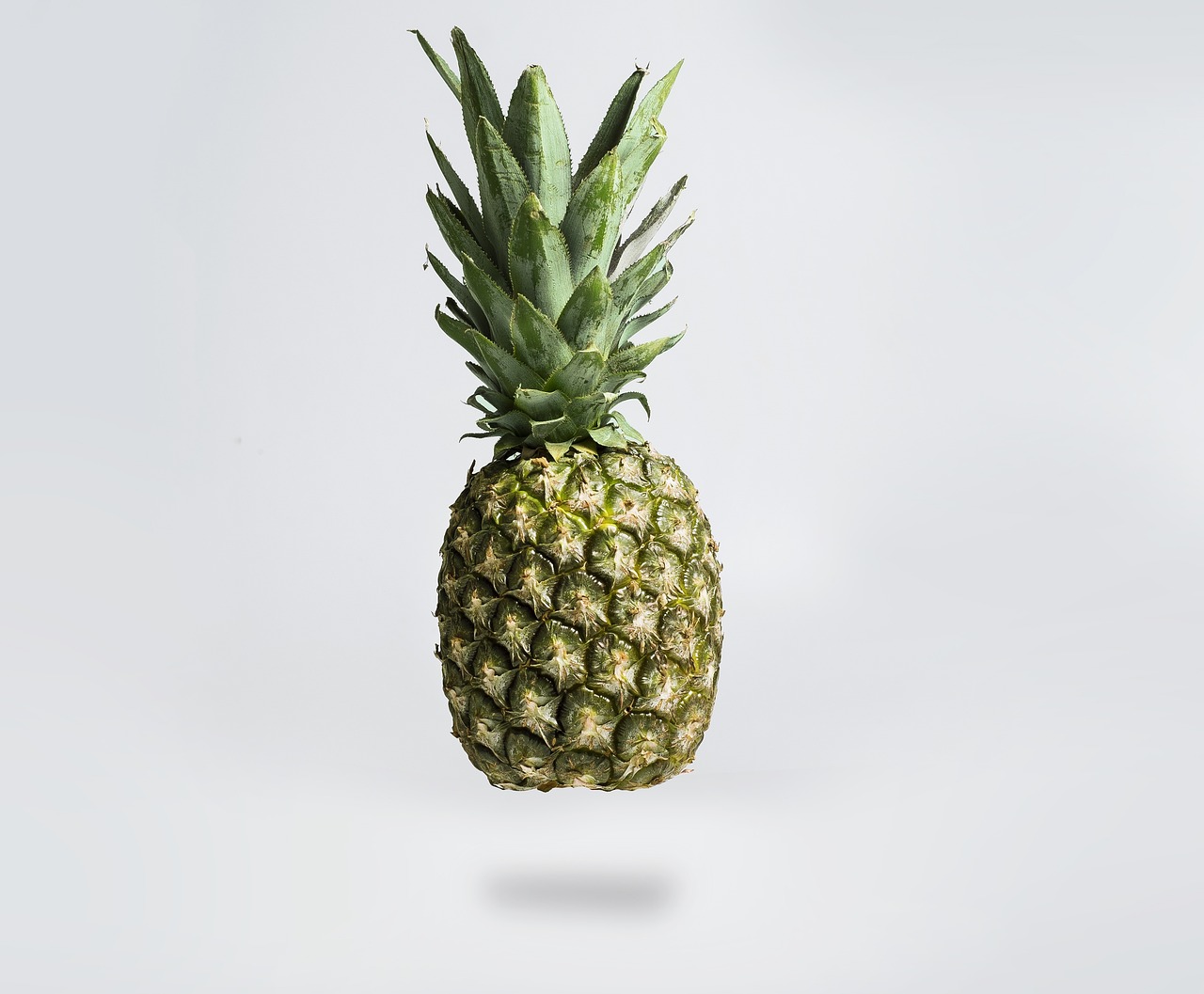 a pineapple floating in the air on a white background, a stock photo, by Simon Gaon, hyperrealism, cinematic shot, on a gray background, amazing simple composition, he is about 60 years old