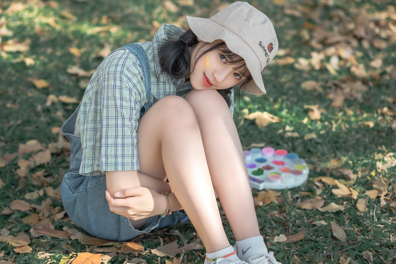 a woman sitting on the ground with her legs crossed, a photorealistic painting, inspired by Yanjun Cheng, tumblr, wearing a cute hat, luts, ( colorful ), photo session