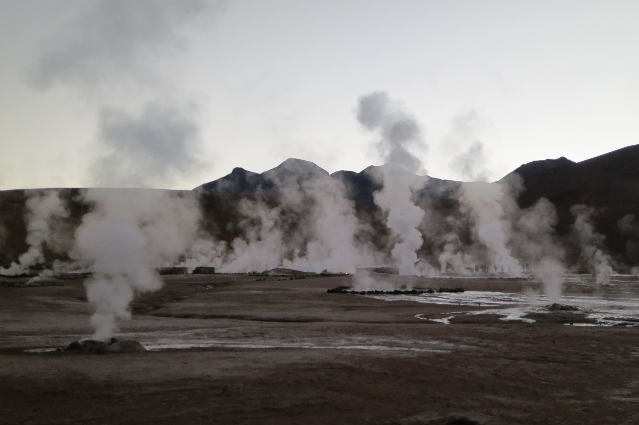 there is a lot of steam coming out of the ground, chile, mutants roaming in the evening, dessert, looking this way