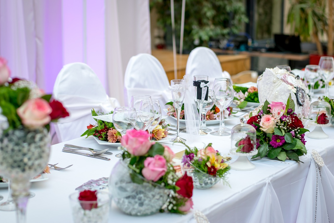 a table that has a bunch of flowers on it, pexels, renaissance, wearing white cloths, modern setting, white and pink cloth, photo taken in 2018