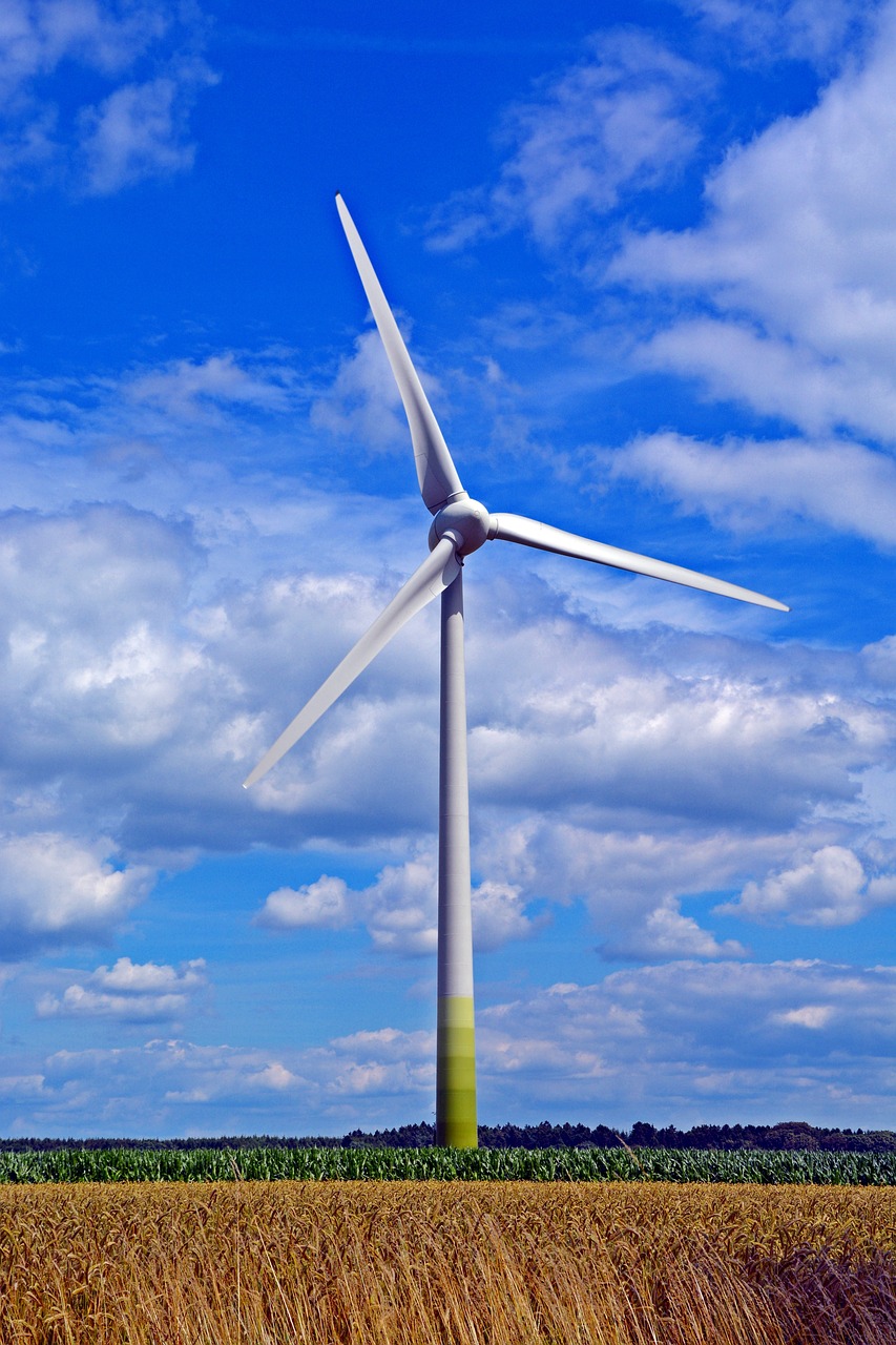 a wind turbine in the middle of a field, pixabay, hurufiyya, cool blue and green colors, partly cloudy sky, inside an epic, istockphoto