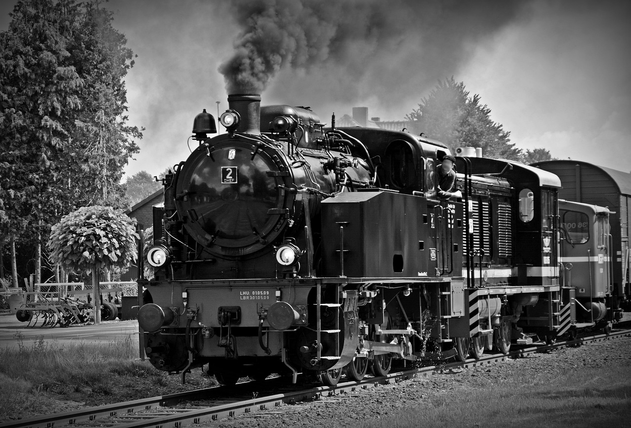 a black and white photo of a train on the tracks, a black and white photo, by Hans Schwarz, pixabay contest winner, gunpowder smoke, attractive and good looking, vintage photo, monochrome color