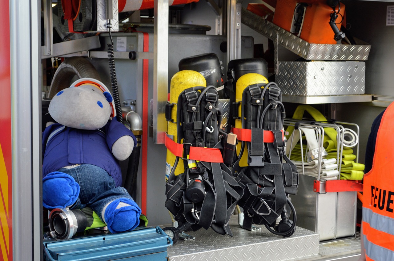 a stuffed animal sitting in the back of a fire truck, a cartoon, by Paul Emmert, shutterstock, harnesses and garters, wide shot photo, jetpacks, stock photo