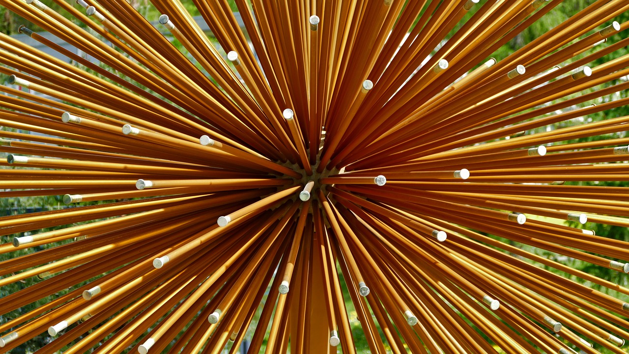 a close up of a bunch of bamboo sticks, a macro photograph, inspired by Bruce Munro, kinetic art, starburst, golden colour, incense, high angle close up shot