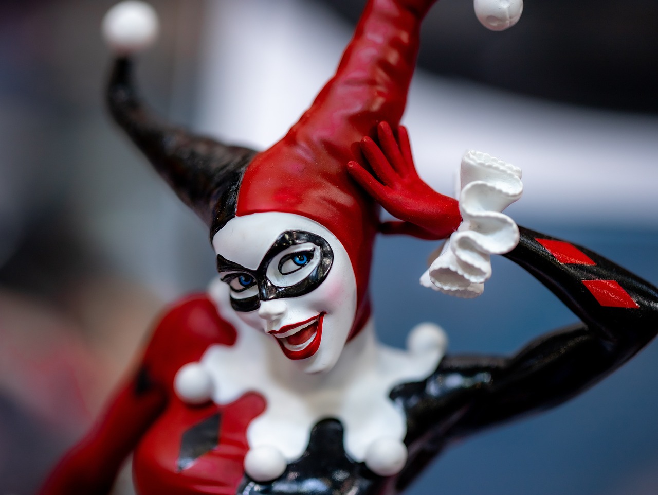 a close up of a figurine of a woman, inspired by Ryan Stegman, of harley quinn, museum quality photo, with a happy expression, shot on sony a 7