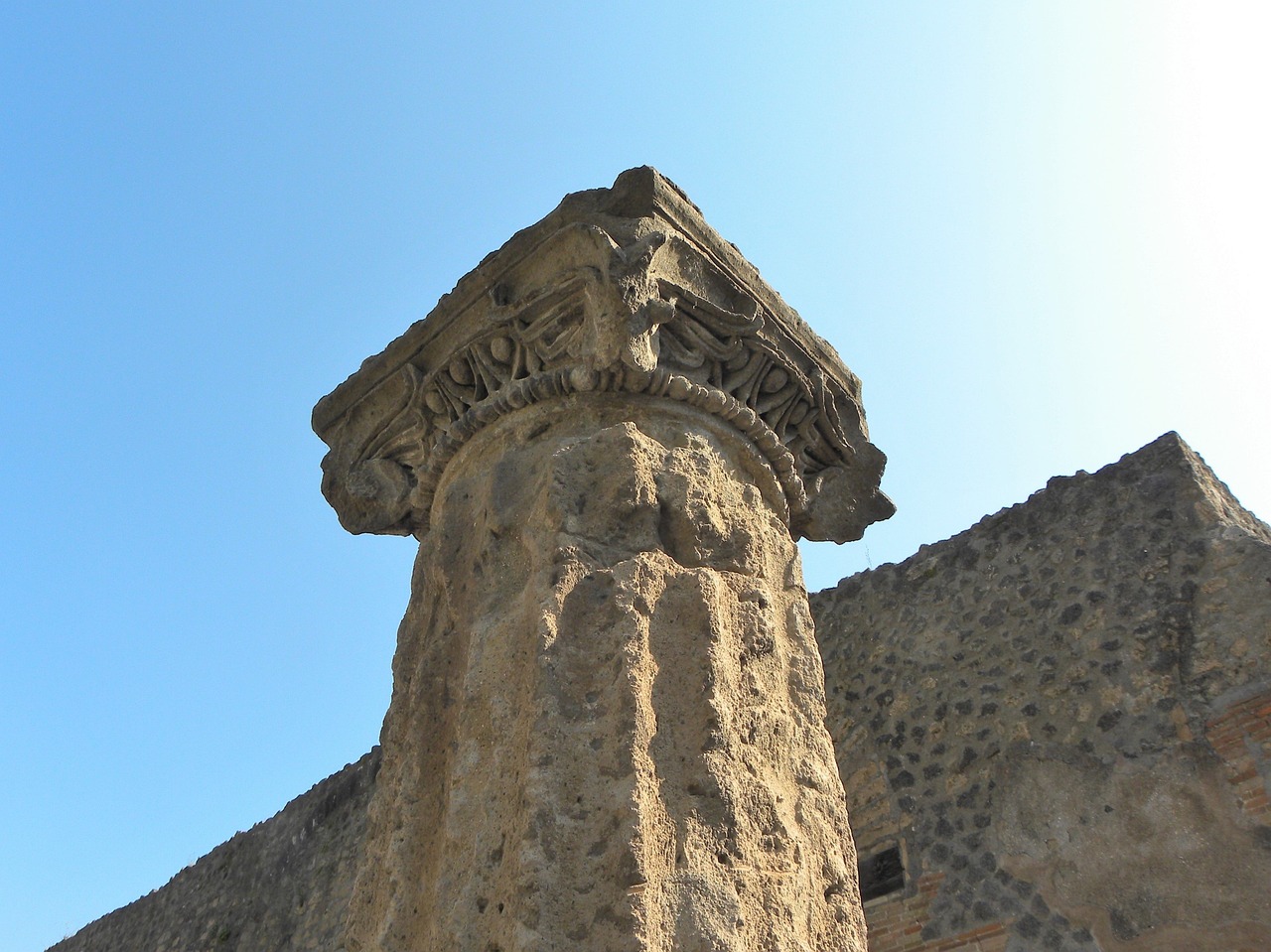 a close up of a stone pillar with a sky background, by Pogus Caesar, flickr, romanesque, found in the ruins of pompeii, bottom view, molten, detailed zoom photo