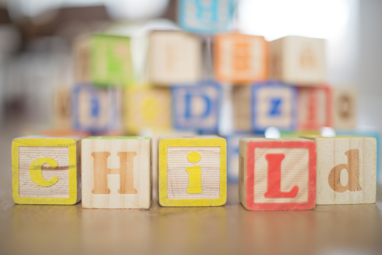 the word child spelled in wooden blocks on a table, by Juan O'Gorman, blurry focus, high res photo, image, julia hill